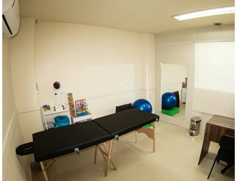 Sala de fisioterapia com maca e equipamentos